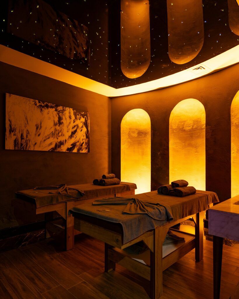Moroccan Hammam Experience Relaxing spa interior with ambient lighting in Bodrum, Türkiye, showcasing massage tables and decor.